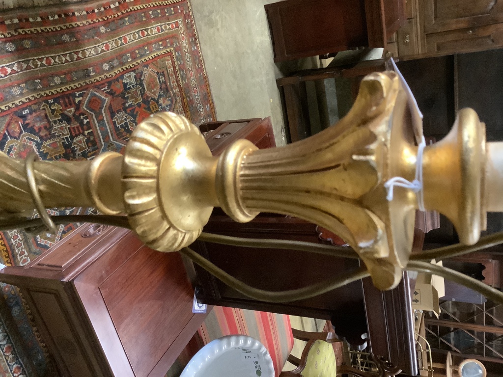 A carved giltwood lamp standard